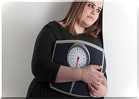 Overweight woman with weight is ready for yoga for weight loss