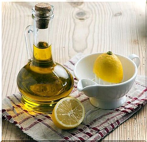 Glass with oil and a lemon in a bowl