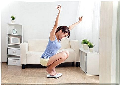 Woman squatting on the scales