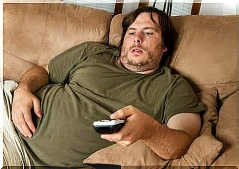 Man lying on sofa with remote control