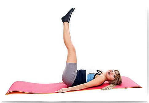 Young woman doing exercise on a mat