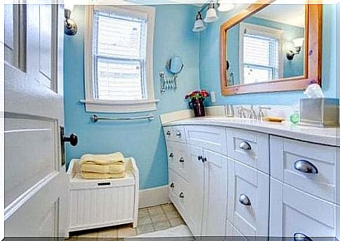 Blue bathroom with white furniture