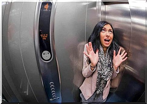 A woman panics inside an elevator