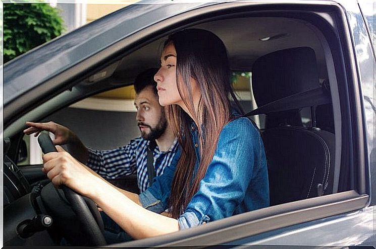 Woman driving a car with a man as a passenger