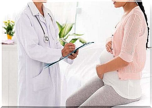 Pregnant woman is checked by a doctor