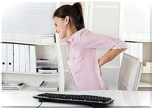 woman in office with back pain