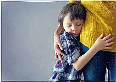 Boy hugs adult due to difficulty adjusting to a new school