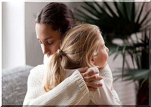 Mother hugs daughter in the process of adjusting to a new school