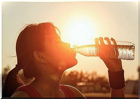 Woman drinking a bottle of water 