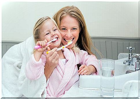 Mother and child brushing teeth