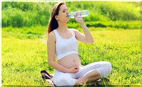 A pregnant woman drinking water