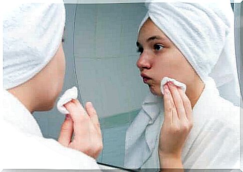 Woman cleanses face