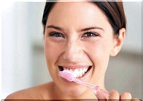 Woman brushes teeth with products to whiten teeth