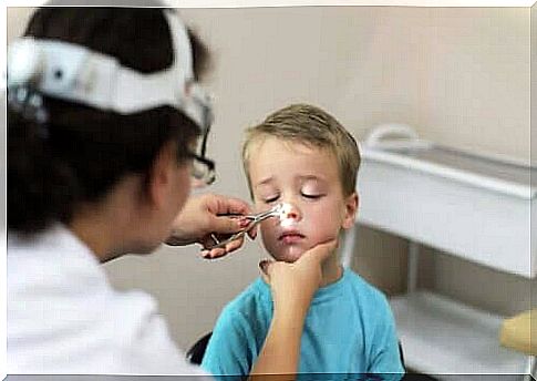 Doctor checks boy's nose for adenoiditis