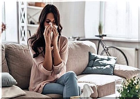 Woman brushes nose due to symptoms of asthma and rhinitis