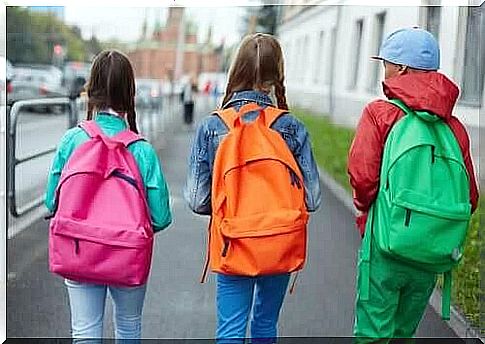 School children with colorful school bags 