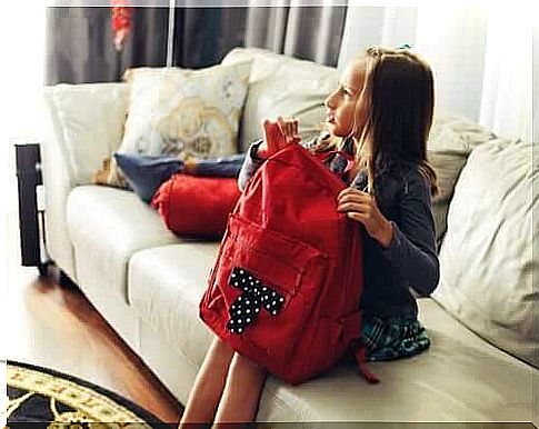 There is a relationship between school bags and back pain, which is illustrated by a girl sitting with a school bag