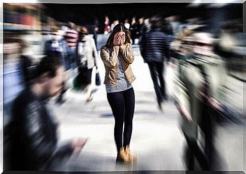 Panicked woman in crowd of plagued by agoraphobia