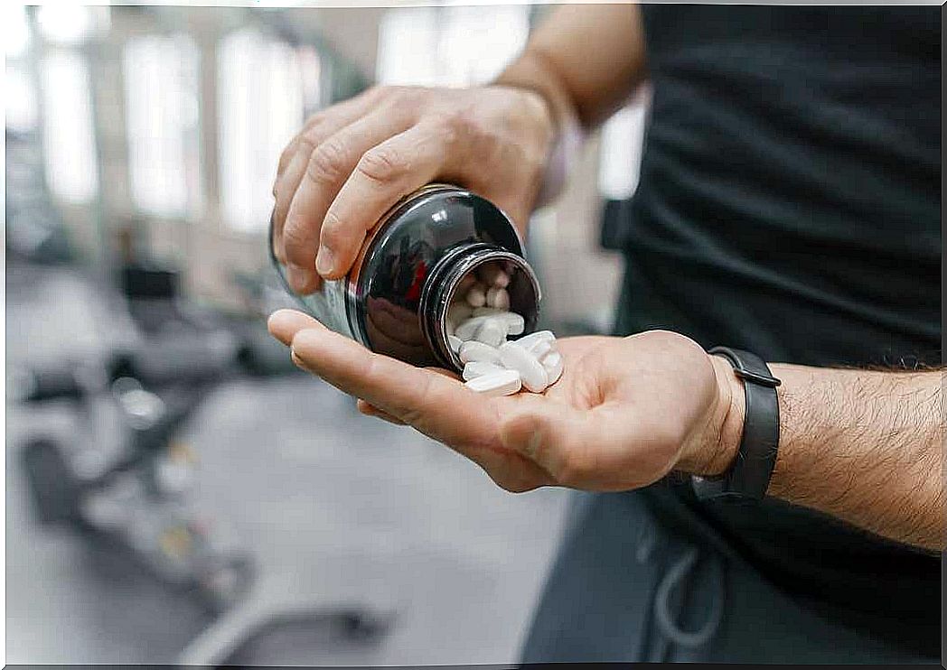 A man pouring vitamin supplements into his hand