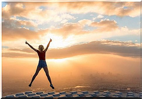 Woman jumping and stretching her arms out